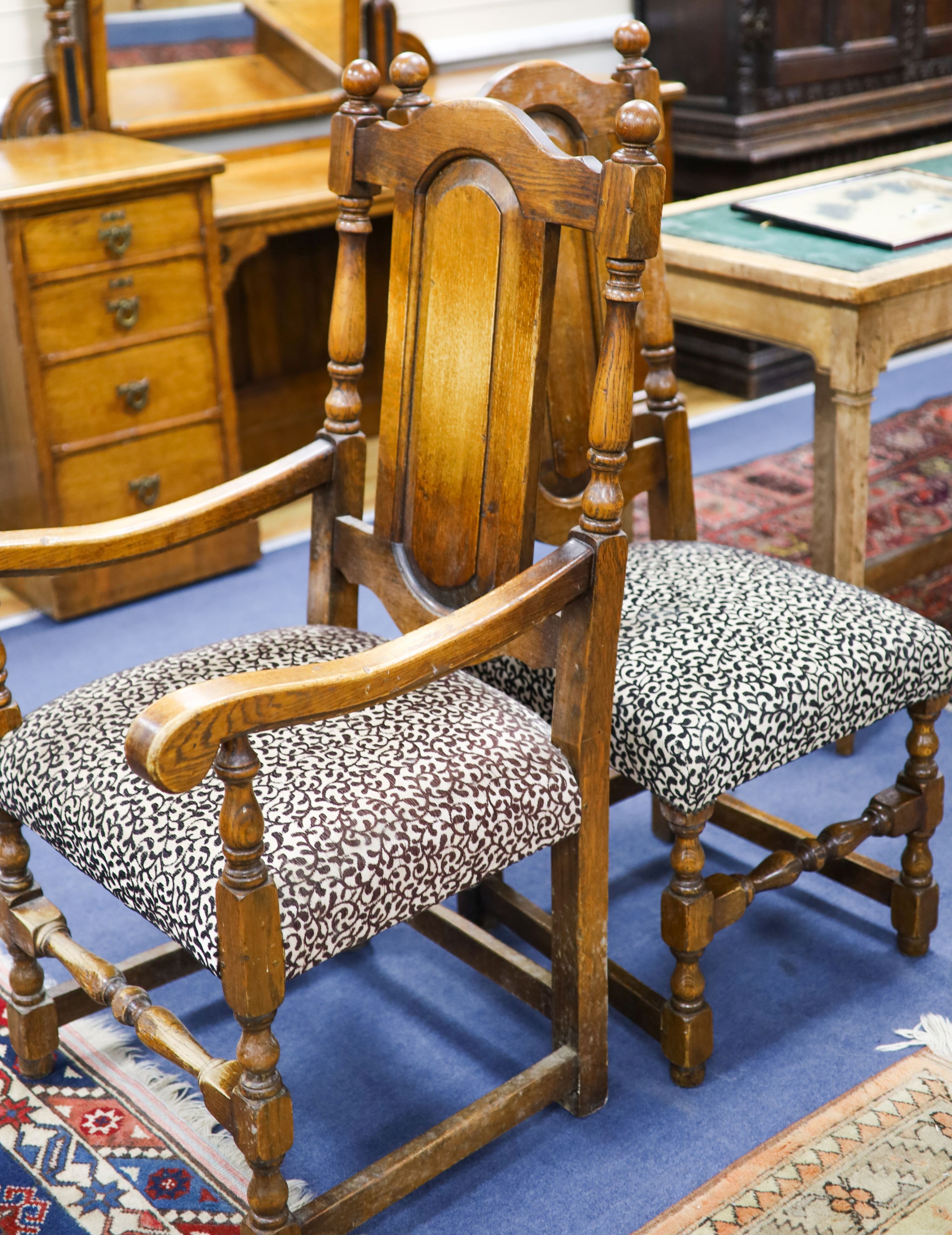 A set of ten 18th century style panelled oak dining chairs, two with arms